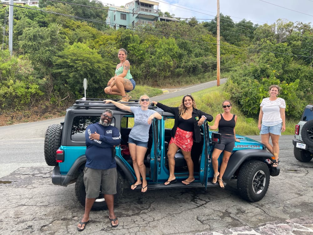 Group of girls posing on Jeep next to driver on Jeep Tour